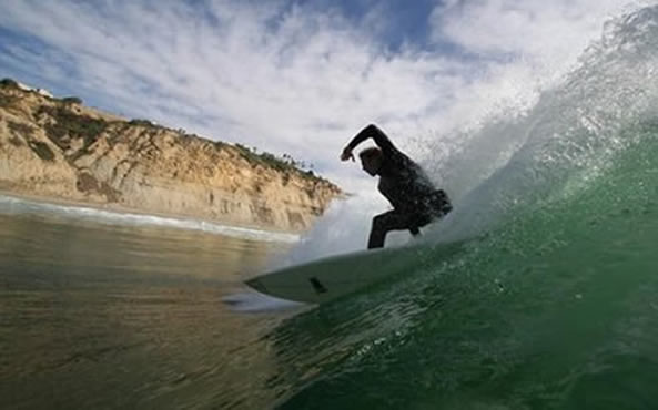 A surfer in the water near Black's Beach, San Diego