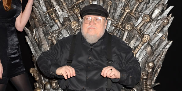 George R. R. Martin seated on the throne from HBO's Game of Thrones