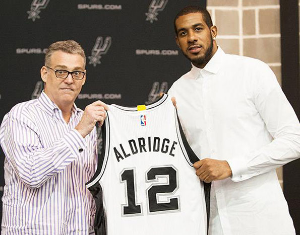 LaMarcus Aldridge holds a Spurs uniform