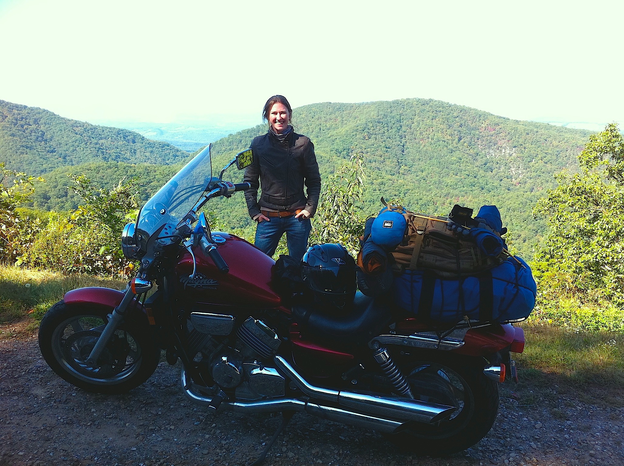 Lily Brooks-Dalton standing behind a motorcycle