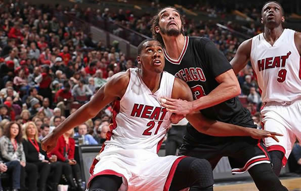 Hassan Whiteside battling Joachim Noah for a rebound