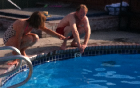 Laura Gibson teaching Nick Jaini how to dive into a pool