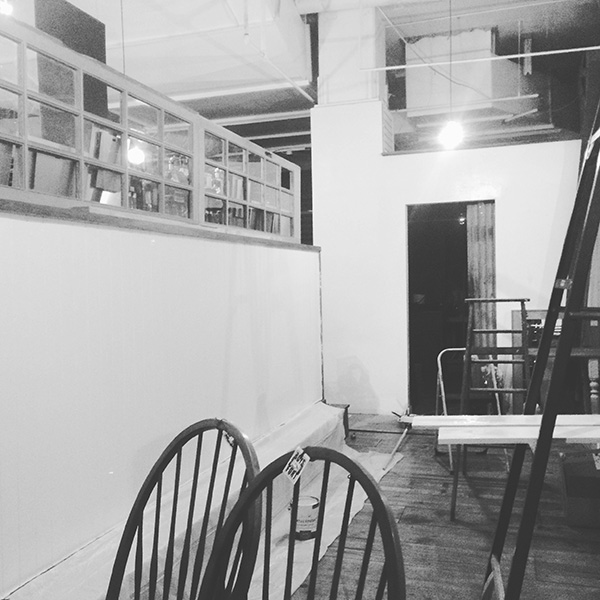 an empty storespace with paint and a ladder