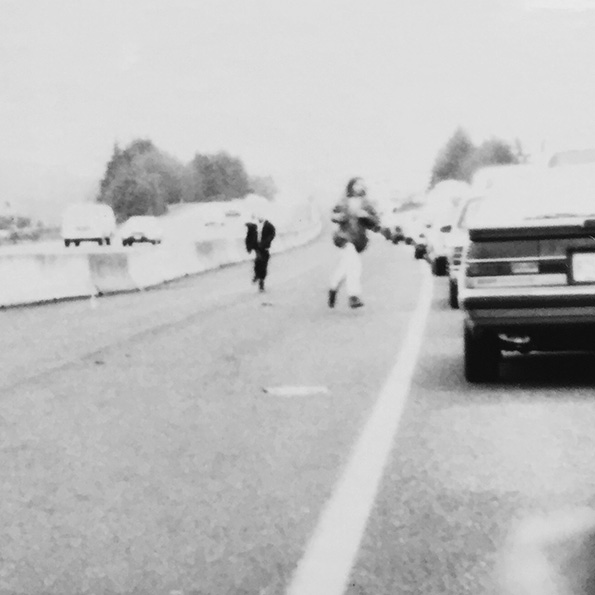 phot of people out of their cars during a traffic jam on a highway