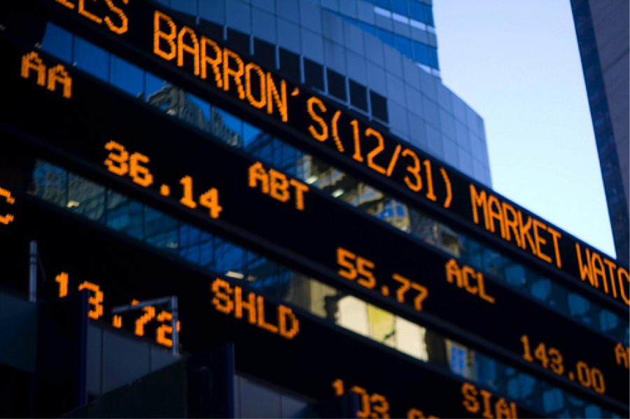 a large, scrolling stock ticker on the side of a building