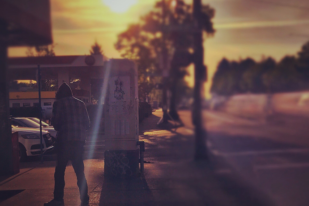 a man walking on the street in a photo by Brian Padian